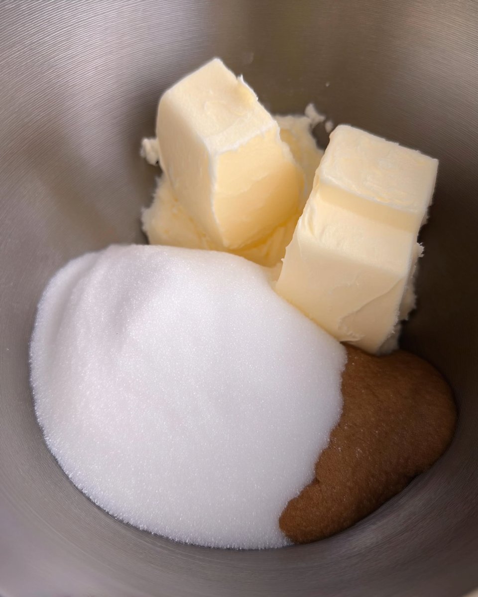An overhead shot of fresh cookie ingredients including spices, browned butter, and Biscoff spread