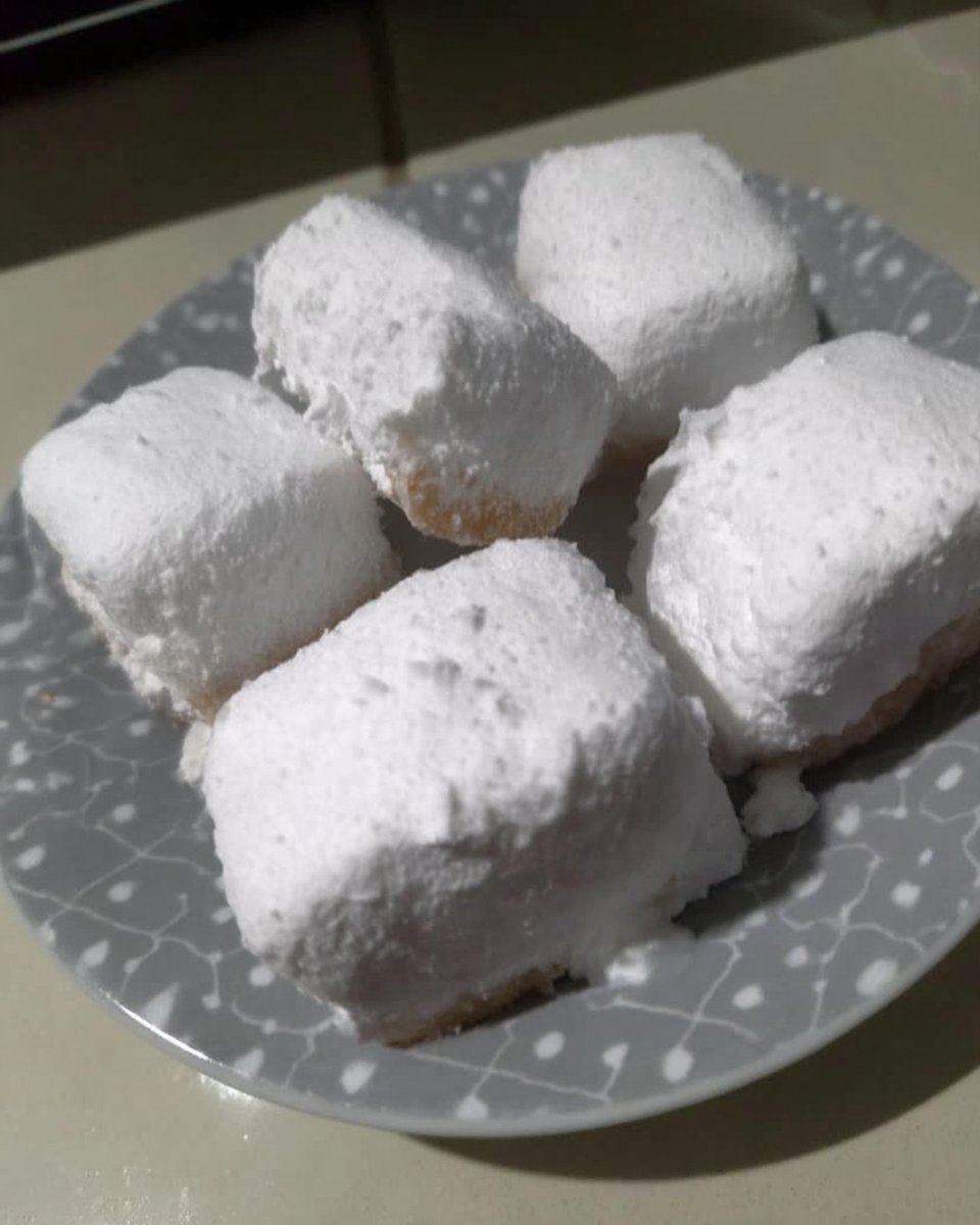 Kourabiedes served with a cup of coffee and fresh orange slices