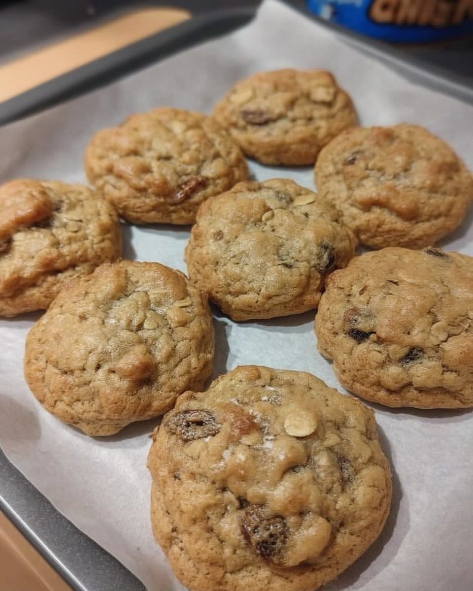Soft oatmeal raisin cookies stack on a rustic wooden table