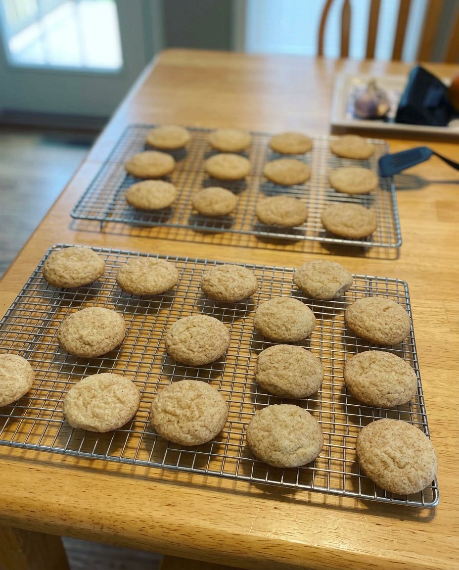 A stack of golden gluten-free snickerdoodles with a visible cinnamon sugar coating
