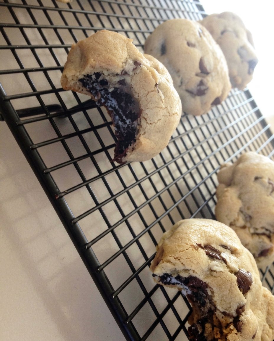 A massive chocolate chip cookie broken open to reveal an Oreo cookie stuffed inside