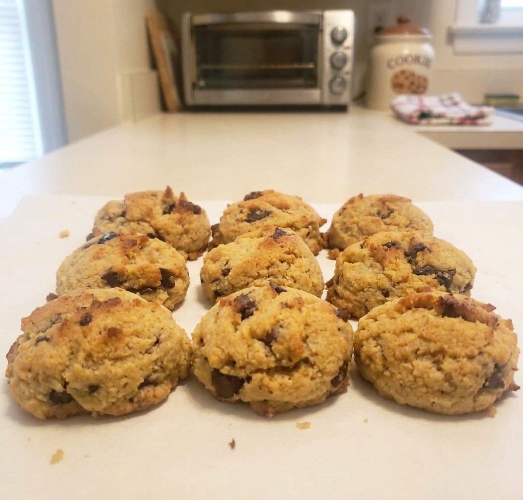 A stack of golden brown paleo chocolate chip cookies with visible dark chocolate chips