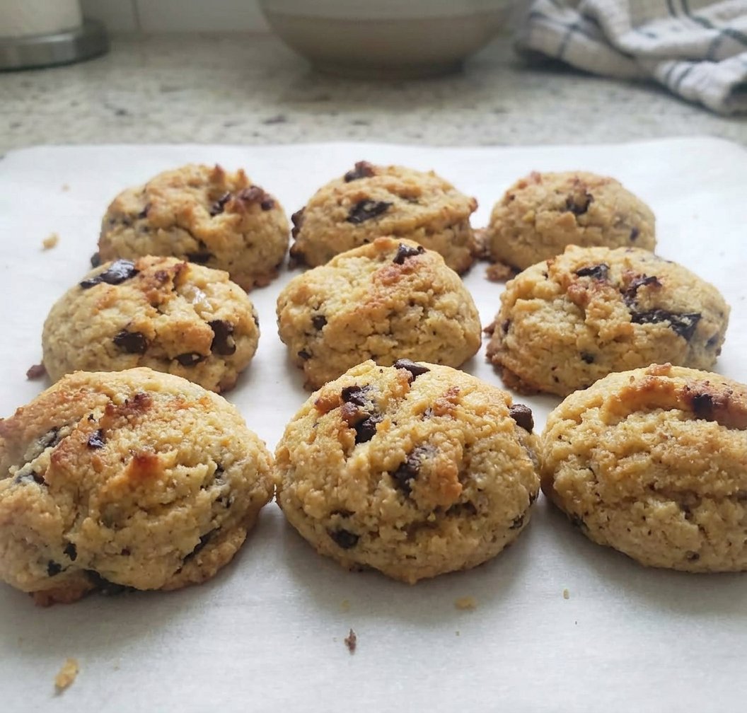 Paleo Chocolate Chip 14 Two paleo chocolate chip cookies on a plate next to a glass of almond milk
