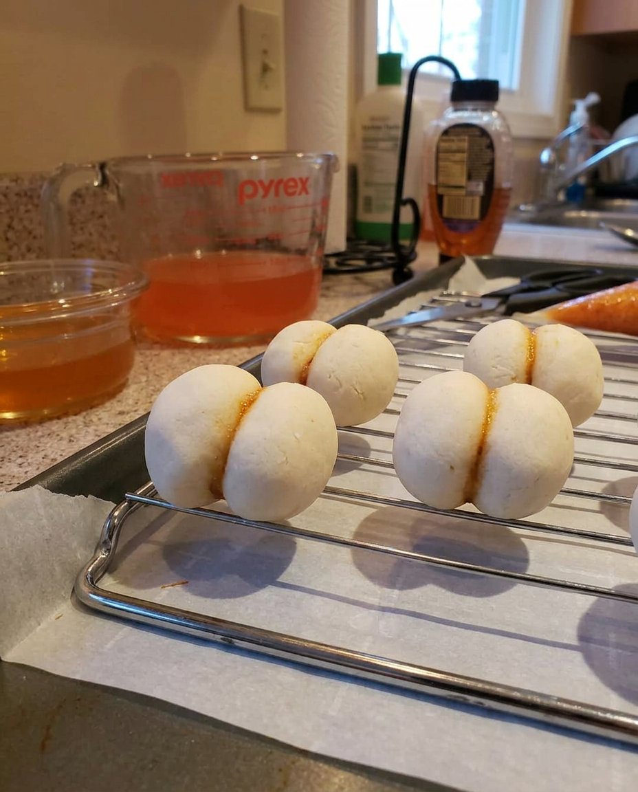 Peach Cookies 13 Baked cookies cooling on a wire rack with a round cutter nearby