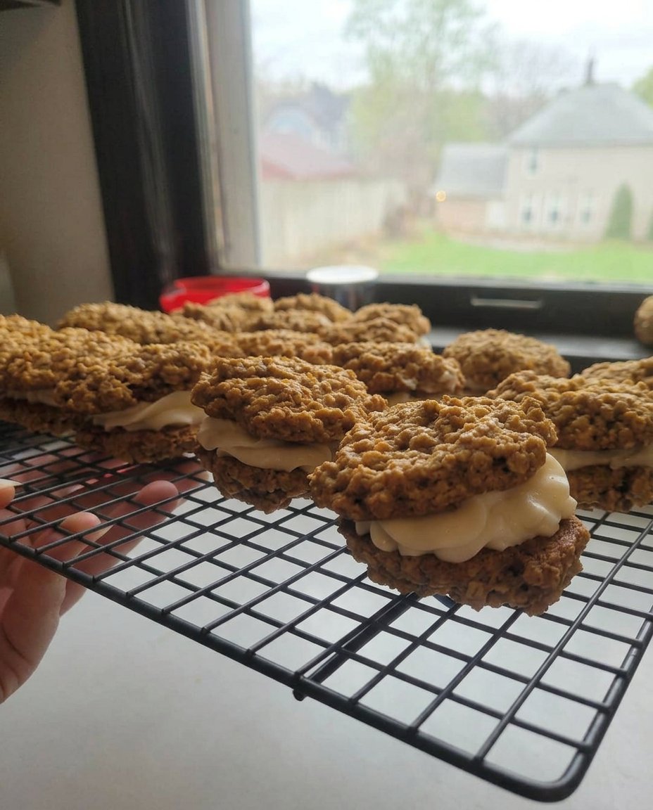 A platter of oatmeal cream pies served with a glass of milk on a farmhouse porch