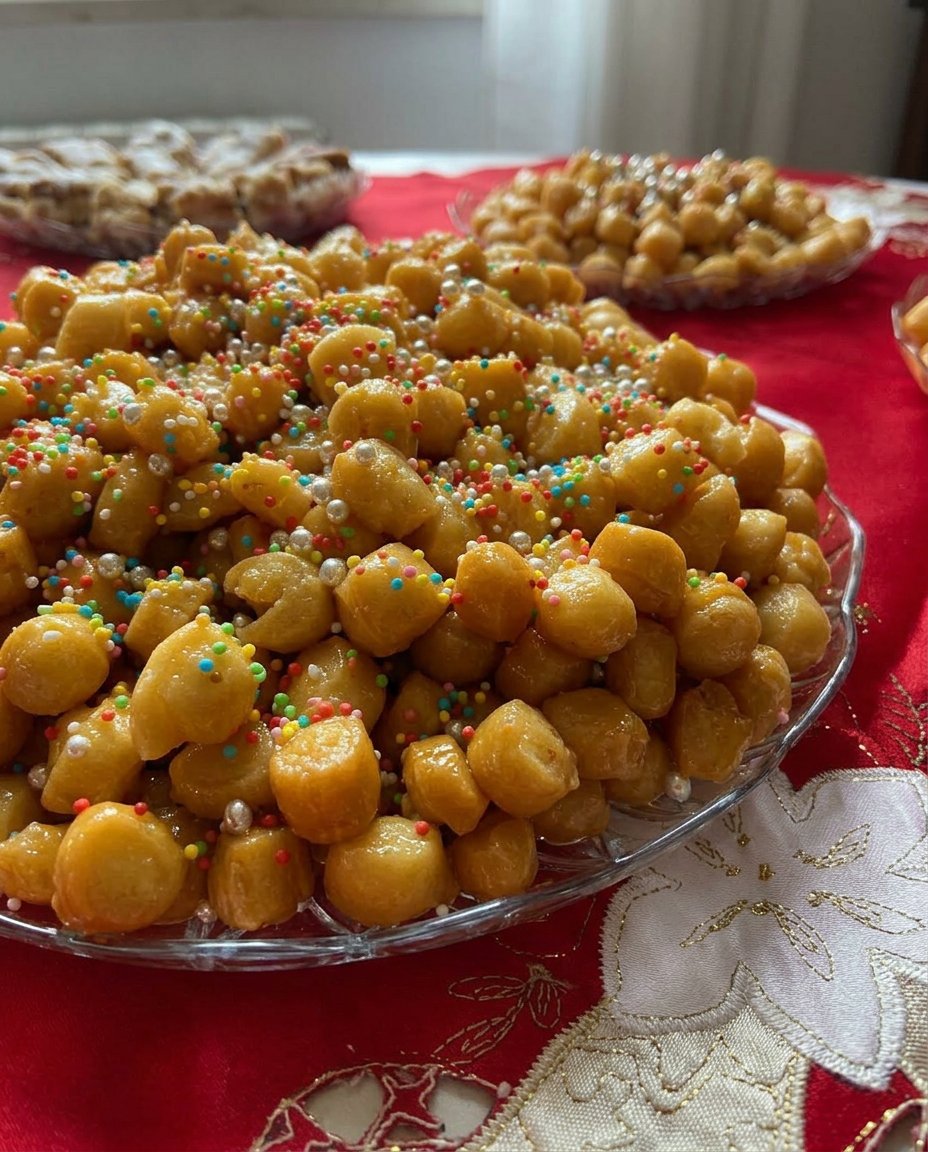 Struffoli 14 Struffoli shaped into a festive wreath on a decorative holiday serving platter.