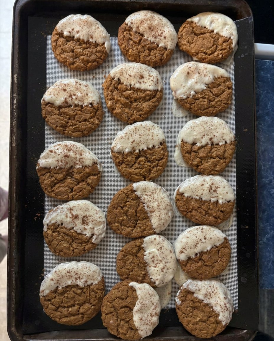 Paleo gingerbread cookies on a rustic wooden board with cinnamon sticks.